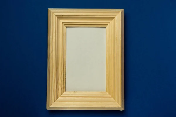 wooden photo frame on solid background