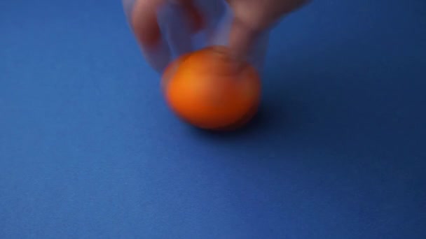 A woman's hand twists a painted chicken egg — Stock Video