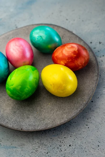 selective focus, painted chicken eggs with food dye, colored marble, concept for light Easter