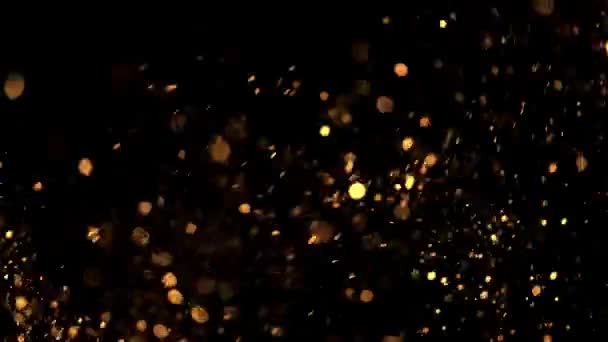 美丽的动画的彩色飞行闪烁颗粒散落在黑色的背景 — 图库视频影像