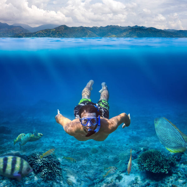  young man snorkeling in sea 