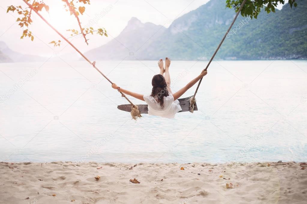 Carefree happy woman swinging 