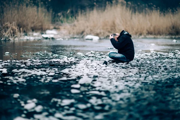 Portrét přízvučné zoufalství člověka sedí na řece. — Stock fotografie