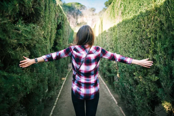 Junge Frau spaziert im Park-Labyrinth — Stockfoto