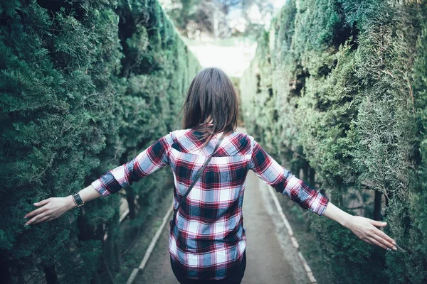 Junge Frau spaziert im Park-Labyrinth — Stockfoto