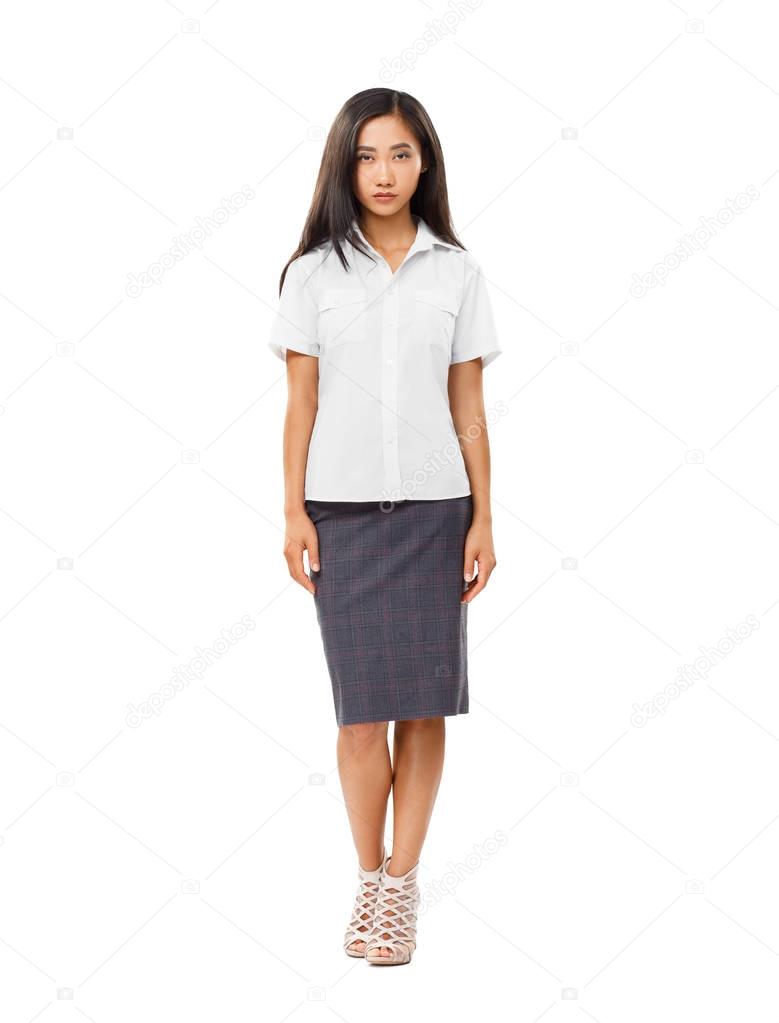 Serious Asian young woman in full length