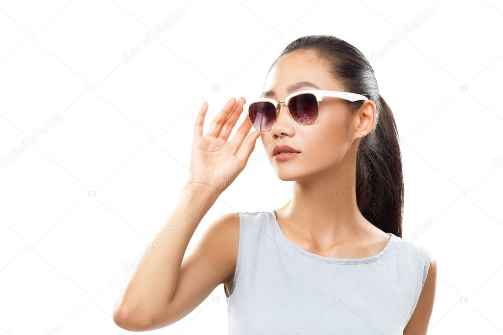 Asian girl touching her sunglasses