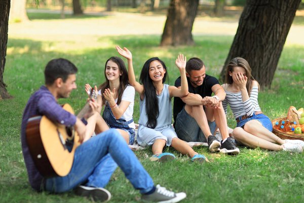 Friends spending weekend in park