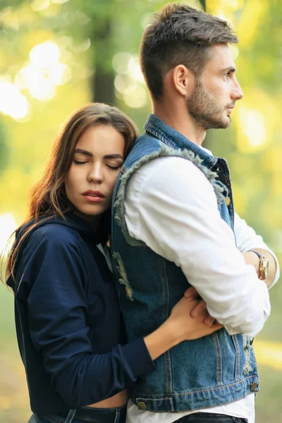 Молодая женщина обнимает мужчину в парке — стоковое фото