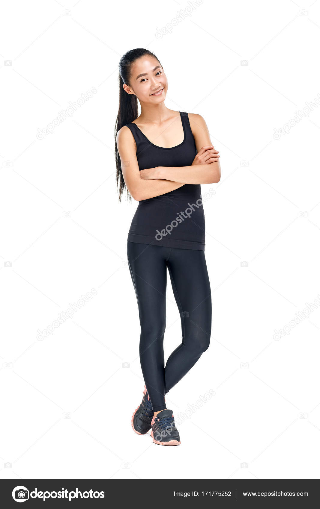 Woman in sportswear standing with crossed arms Stock Photo by ©Gladkov  171775252