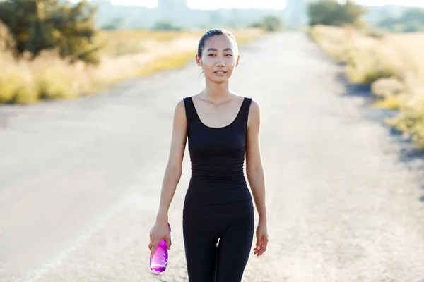 woman carrying water bottle