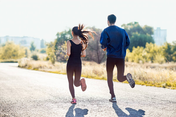  young couple running on road
