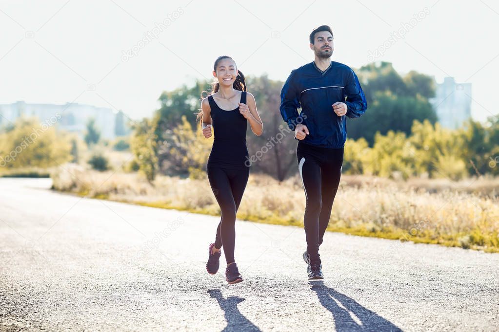  young couple running on road