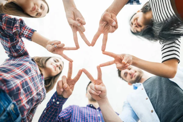 Five young smiling people make star shape from fingers — Stock Photo, Image