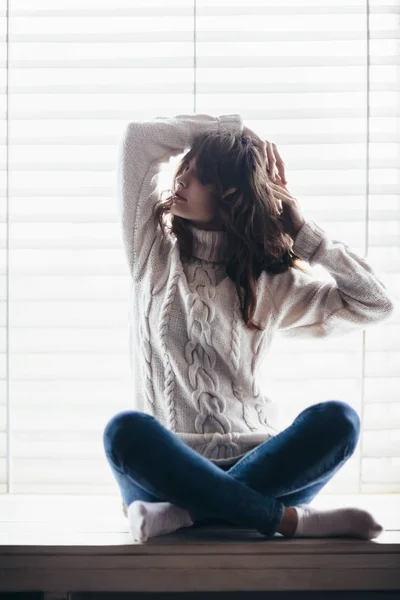 Woman posing on window sill — Stock Photo, Image