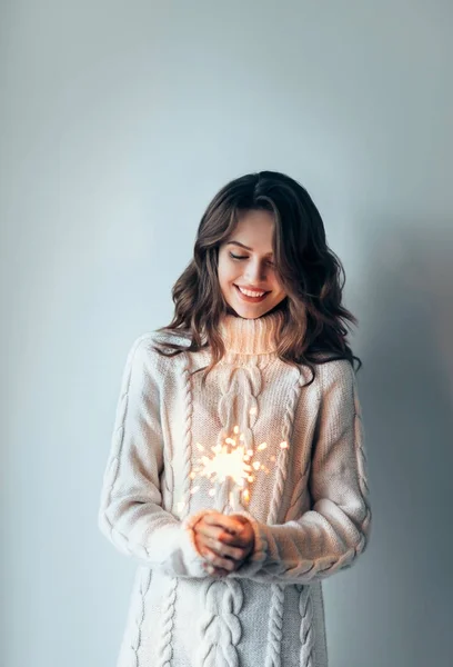 Woman holding festive sparkler — Stock Photo, Image