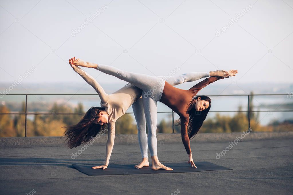 women doing yoga asana Ardha Chandrasana 