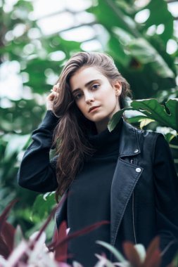 Doğa arka plan üzerinde deri ceketli güzel şık kadın moda portre