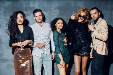 Genç arkadaşlar şampanya içip gece kulübünde takılıyorlar.