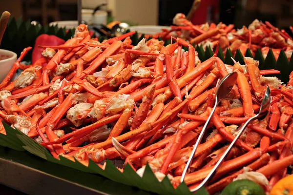 Cooked coconut crab legs served in a buffet tray