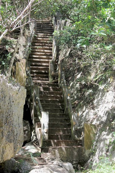 A long flight of cemented steps among corals and rock formations heading to the Grotto dive site, Saipan