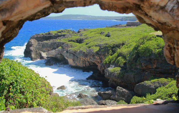 An arc from bricks form a frame for a beautiful scenic view of Saipan's coasts