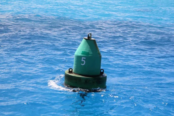 Derin deniz alanı nın teknecileri uyarmak için okyanusta yüzen yeşil buket