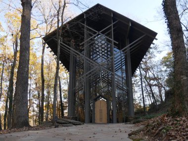 Wide shot of the Thorncrown Chapel bordered by trees , Eureka Springs, Arkansas. clipart