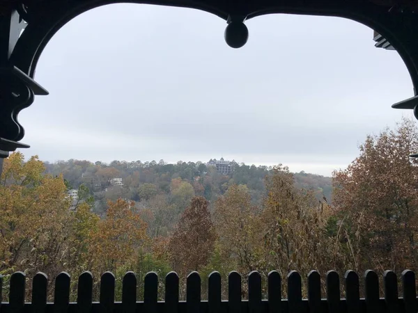 Colorful trees in autumn, with the Crescent Hotel & Spa in the distance at Eureka Springs, Arkansas.