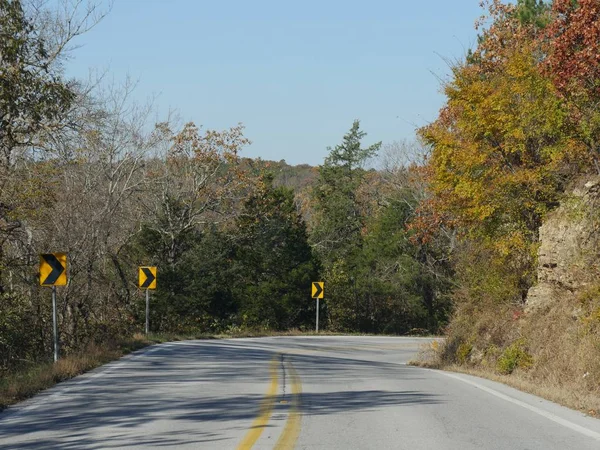 Warning signs on a sharp curve at a road in Arkansas.