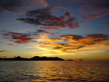 Gorgeous clouds in the skies reflected in the sea at sunset