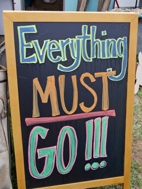 Handmade sign on a small chalkboard at a flea market