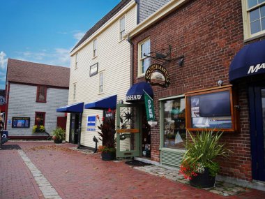 Newport, Rhode Island-September 2017: Brick-paved sidewalks and brick buildings housing souvenir shops and stores at the waterfront area in Newport.