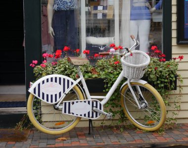 Newport, Rhode Island-September 2017:A painted bicycle parked outside a clothing store at the wharf in Newport.
