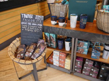 Newport, Rhode Island-September 2017: Assorted coffee products and coffee mugs inside a Starbucks Coffee shop at Thames Street, Newport.