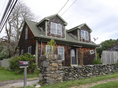 Jamestown, Rhode Island-September 2017: Beautiful old house beside the 1787 Jamestown Windmill, one of the attractions along the road in Rhode Island.