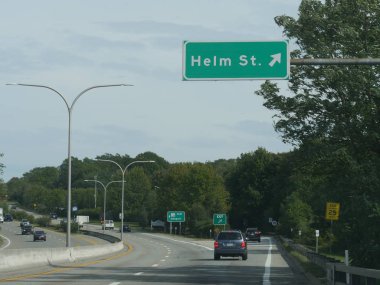 Jamestown, Rhode Island-September 2017: Directional signs on the road to Helm Street with vehicles traveling on the road.