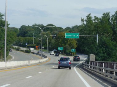 Jamestown, Rhode Island-September 2017: Wide shot of directional signs on the road to Helm Street with vehicles traveling on the road.