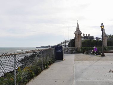 Newport, Rhode Island-September 2017: The Newport Cliff Walk, one of the top attractions and activities tourists and locals walk along Easton Bay, clipart