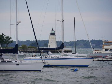 Newport, Rhode Island-September 2017: Boats at the Goat Island with the Newport Harbor Lighthouse in the background.