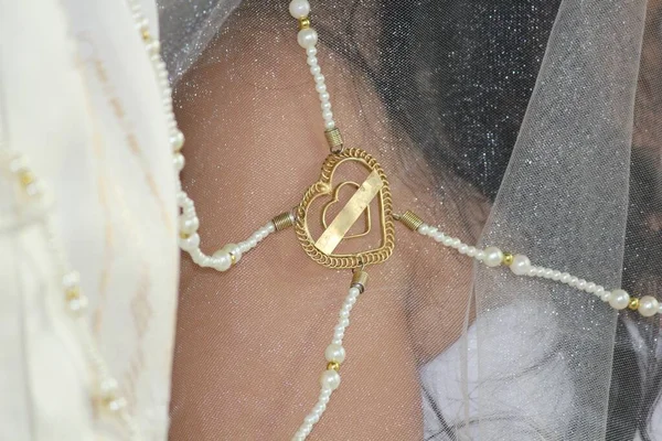 Lace veil locked with a gold heart in a Filipino traditional wedding