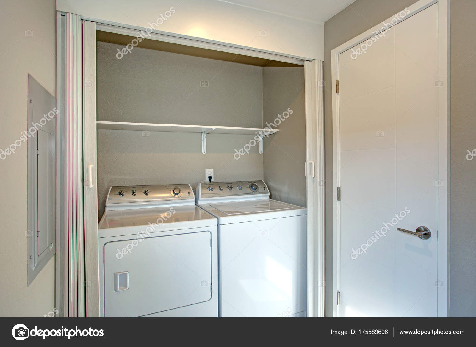 Laundry Room Hidden Behind White Folding Doors Stock Photo