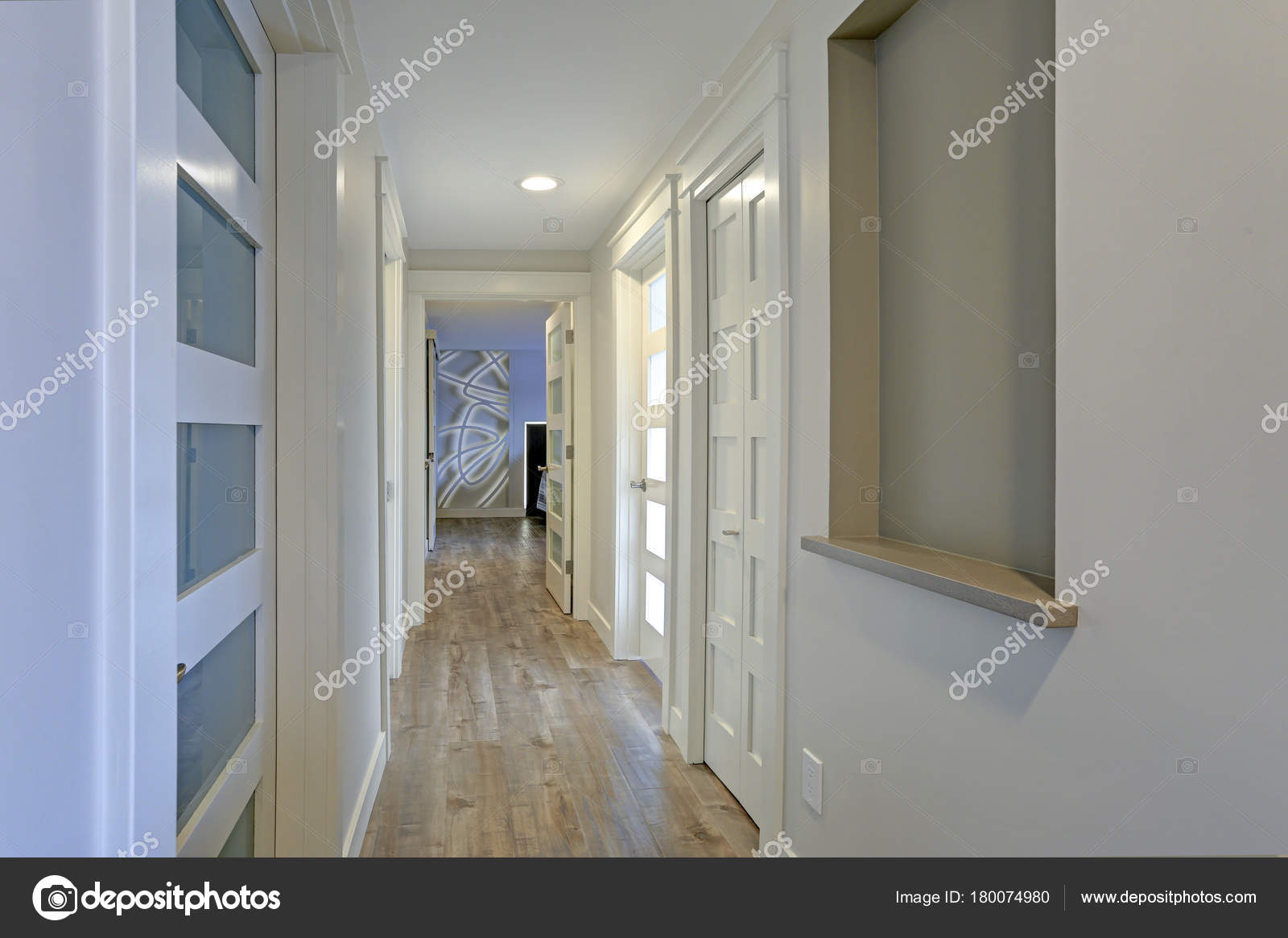 Long Narrow Corridor With White Doors Accented With Glass