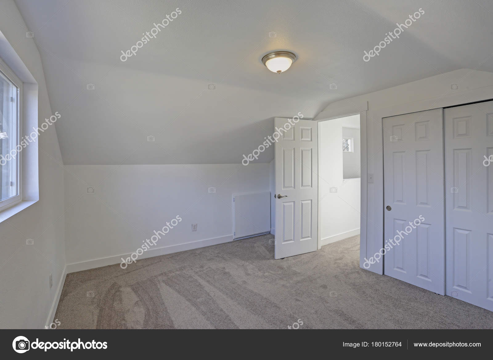 Empty Bedroom Interior With Vaulted Ceiling On The Upper