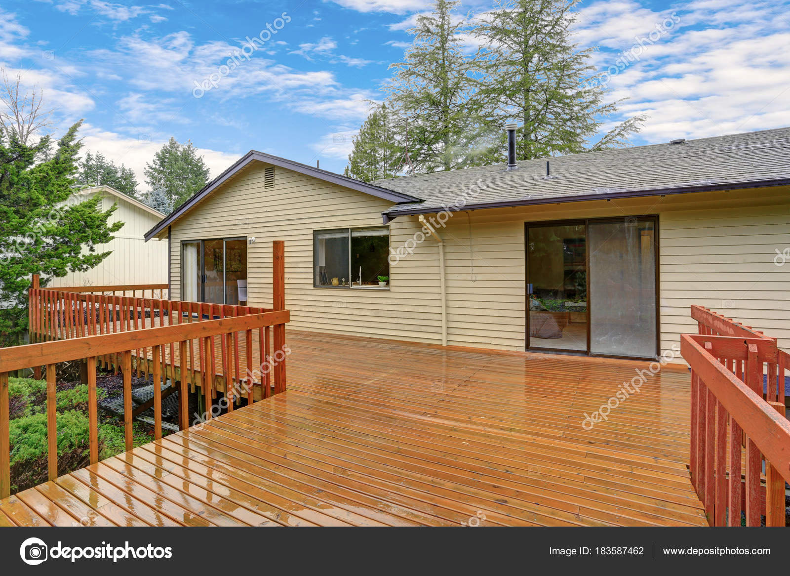 Backyard View Of A Spacious Two Story Home With Walk Out Deck