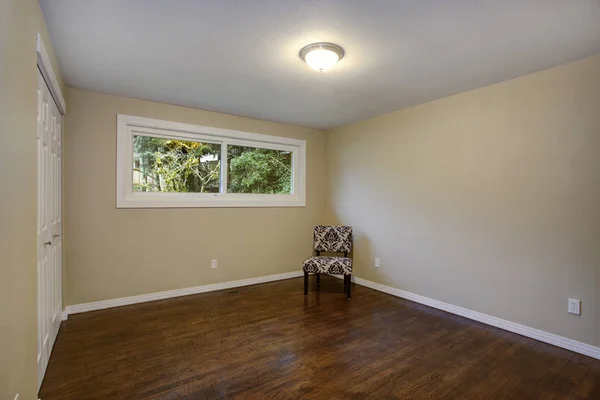 Empty room, taupe walls, hardwood floor in a luxury home.