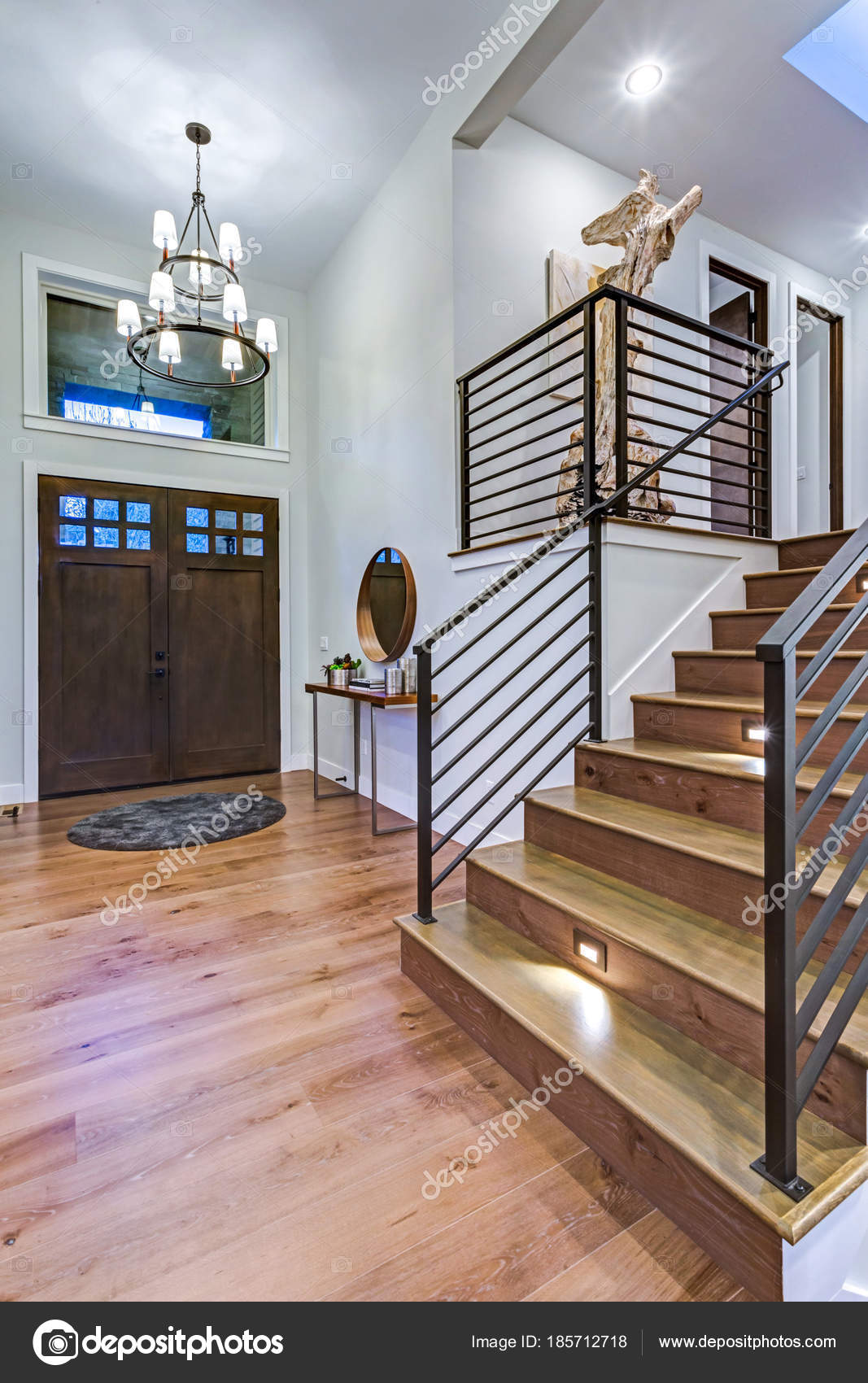 Chic entrance foyer with high ceiling and white walls. Stock Photo