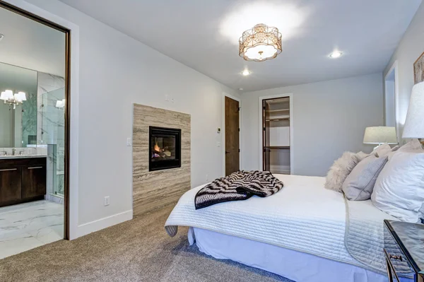 New luxury custom built home with white master bedroom.