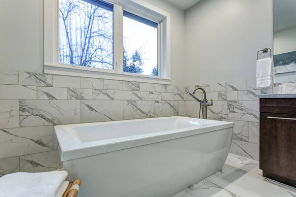 Incredible master bathroom with Carrara marble tile surround.