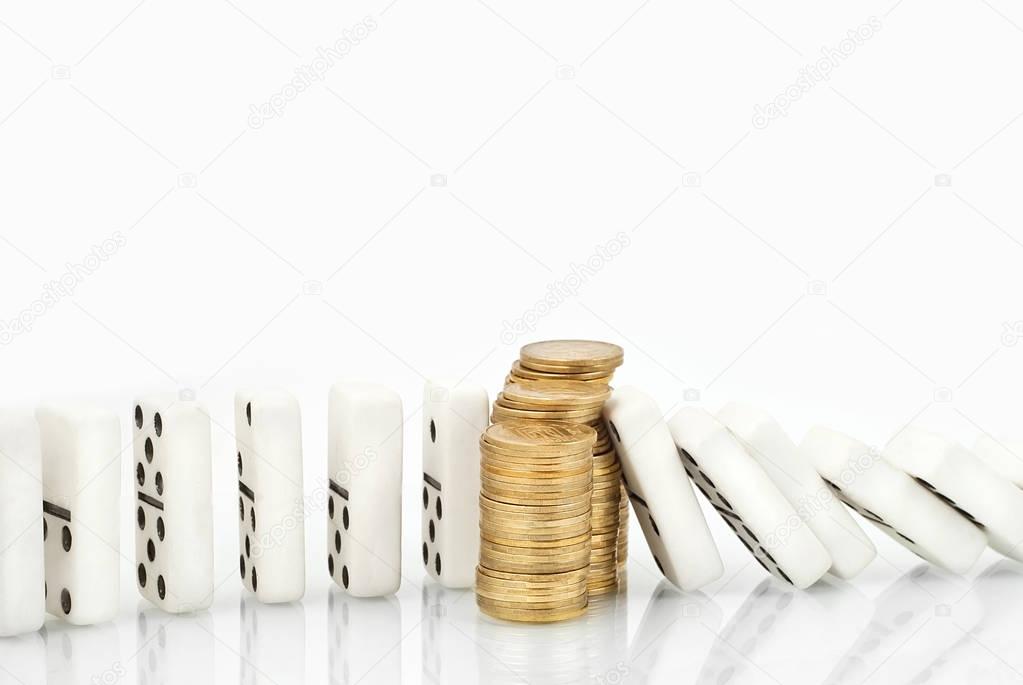 domino falls on a stack of coins